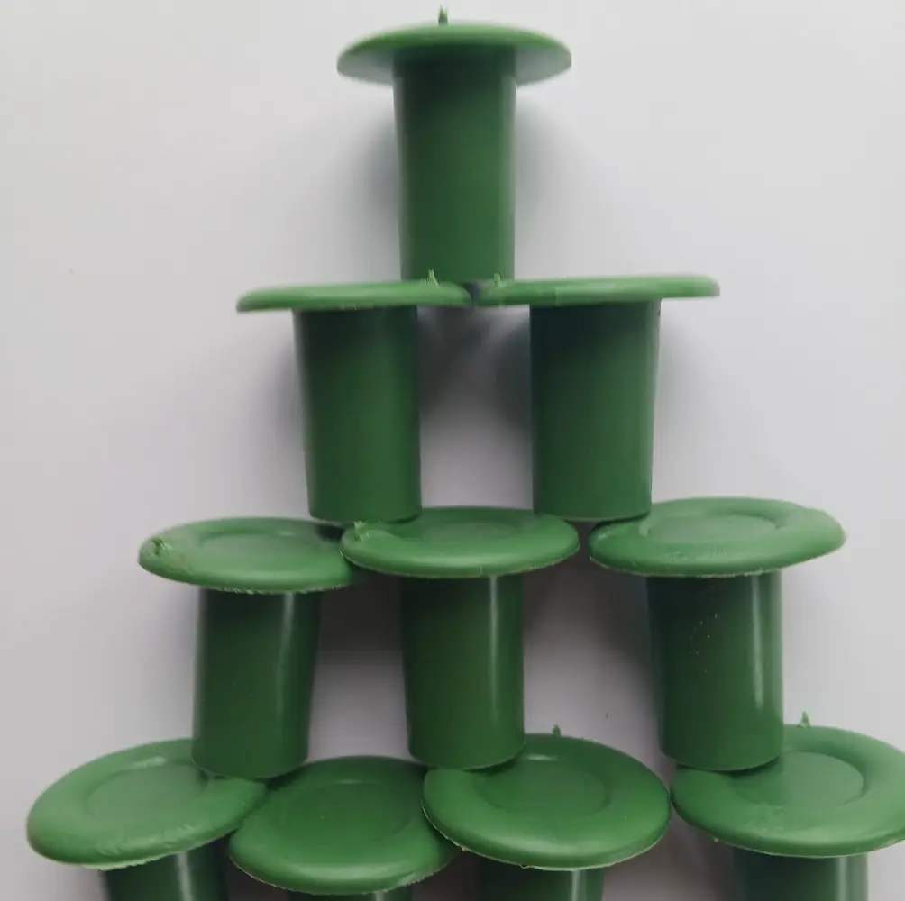 A close-up of Rubber Cane Caps (Green), durable rubber caps designed to fit over the ends of cane supports, ideal for protecting plants in UK gardens.